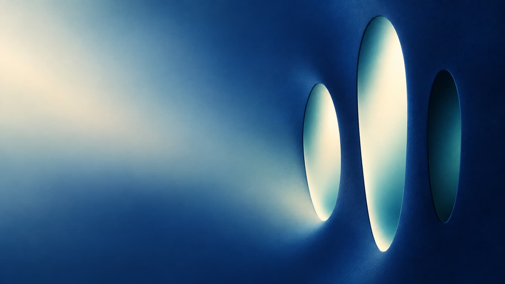 Three unequal optical openings admit different amounts of pale light.