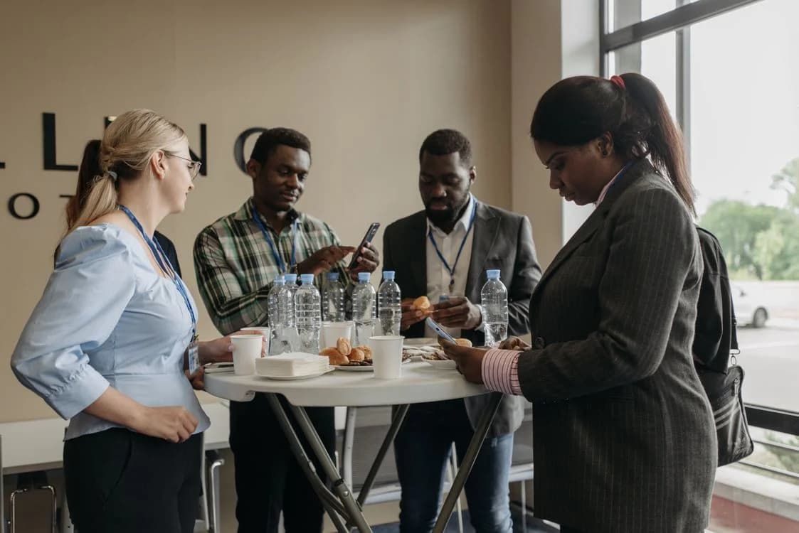 Stock photograph of professionals networking during a conference break
